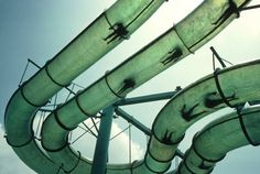 an image of a large pipe going up the side of a building with sky in background