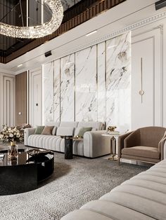 a living room filled with furniture and a chandelier hanging above the couches