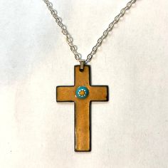 A timeless enameled copper cross, good for all ages. A layer of transparent golden glass enamel fired onto a copper cross at 1500˚F, allowing the natural sheen of the metal to shine through, with a glass millefiore stone in the center. The back side is enameled black. Cross is 2" x 1 1/4"  Choice of black or natural leather,  or cable chain. 16", 18" or 22"   Browse more Kickglass Enamels necklaces here https://www.etsy.com/shop/kickglassenamels?section_id=7232499 Shop home: kickglassenamels.ets Jewelry Cross Necklace, Necklace Christian, Jewelry Cross, Enameled Copper, Enamel Necklaces, Black Cross, Christian Jewelry, Enamels, Religious Jewelry