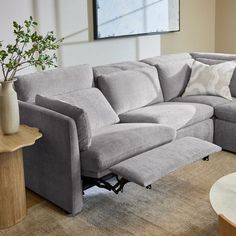 a living room with a sectional couch and coffee table