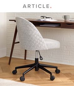 an office chair sitting in front of a desk with the words article written on it