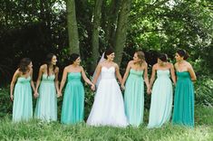 a group of women standing next to each other holding hands