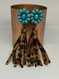 Leopard print and fringe make these earrings a must have! The tassels are made from high quality faux leather and the inlaid turquoise in either cream or blue adds a great pop of color. Approximately 4 inches in length. Turquoise Beaded Fringe Dangle Tassel Earrings, Elegant Turquoise Tassel Earrings For Gifts, Elegant Turquoise Earrings With Fringe, Elegant Handmade Turquoise Tassel Earrings, Turquoise Fringe Tassel Drop Earrings, Leopard With Turquoise Jewelry, Bohemian Turquoise Tassel Earrings, Bohemian Turquoise Leather Earrings, Blue Cream