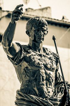 a statue of a man holding a baseball bat in his right hand and pointing to the sky