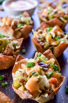 small appetizers with meat, vegetables and sauces on a blue tablecloth