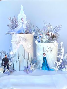 there are two cakes with frosting and decorations on top of them, one has frozen princess figurines