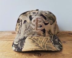 Rare true vintage 90's Florida State University Seminoles strapback hat by Global Caps c. 1994.  Made in Hong Kong   Condition: Deadstock, like new with tag.  *Note* Camouflage patterns vary with each hat (no two were made alike) so the hat shown is a sample of the one you'll receive  Adjustable strap fits most adult hat sizes 6 7/8 thru 7 5/8 Checkout all our unique vintage hats! Click here: https://www.etsy.com/shop/HatsForward ..whenever you're purchasing multiple hats we automatically combin Sports Hats, Hat Aesthetic, Florida State University, Florida State Seminoles, Cute Notes, Sport Hat, Strapback Hats, Camouflage Patterns, Florida State