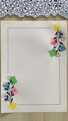 a piece of paper with flowers on it next to a doily and flower border