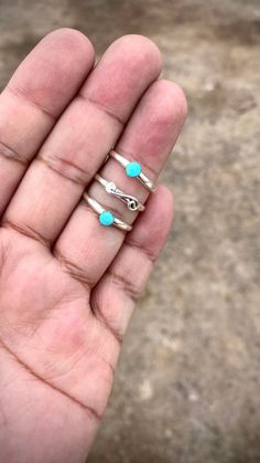 This Chaco Canyon ring set features two gorgeous Kingman Blue Turquoise stones set in a unique swirl design. Handcrafted by Navajo artist Jimson Belin, the three-shank ring provides a bold and elegant look. Elevate your style with this stunning ring. Blue Stackable Toe Rings, Turquoise Three Stone Ring For Gift, Turquoise Three Stone Ring As A Gift, Unique Spiral Turquoise Jewelry, Chaco Canyon, Turquoise Stones, Turquoise Rings, Swirl Design, Blue Turquoise