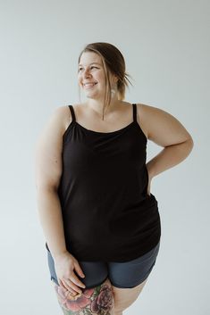 Introducing our Basic Layering Cami, the must-have piece for your wardrobe. Adjustable straps, scooped neckline, and tunic length make it perfect for layering under any outfit. With a slim fit and available in plus sizes, it's a versatile addition to any look. Don't just take our word for it, try it in every color! Fits true to size. We suggest going with your typical size. The cami is intended to be fitted. If you would like it to fit loose, we suggest going up one size. Leslie is wearing a siz Black Tank Top With Built-in Bra For Loungewear, Casual Black Camisole For Loungewear, Black Camisole With Built-in Bra For Layering, Black Cami Tank Top For Loungewear, Black Tops With Adjustable Straps For Loungewear, Black Spaghetti Strap Loungewear Top, Versatile Black Scoop Neck Top, Black Camisole With Built-in Bra And Wide Straps, Stretch Tops With Adjustable Straps For Everyday