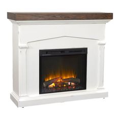 a white fireplace with an electric fire in the center and logs on it's sides