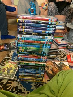 a pile of children's dvds sitting on top of a table next to each other