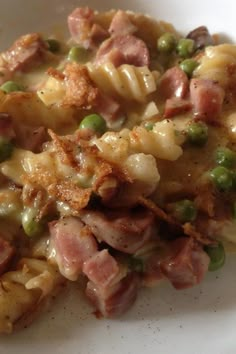 a white plate topped with pasta and meat