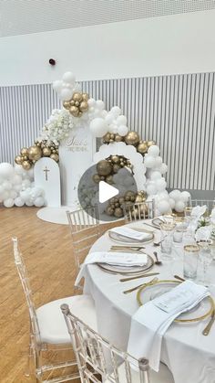 a table set up with white and gold decorations