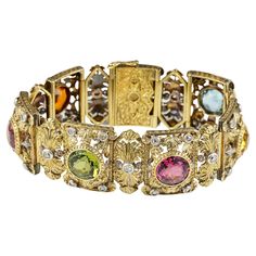 This magnificent Edwardian era bracelet loaded with 36.00 Ct of coloured gemstones, untreated and totally natural It displays extraordinary workmanship of the period, superb and intricate work of leaf and scroll work making it quite an unique Hand made of solid 18 KT gold – substantial in weight being 76.0 grams Set with four natural Topaz of various colours: Pink , Yellow, Blue and Peach Orange denominated as Imperial for the special colour Further more two Hot Pink and Green Tourmaline and one Era Bracelet, Gold Link Bracelet, Art Deco Bracelet, Antique Bracelets, Pink Topaz, Sapphire Bracelet, Edwardian Era, Gemstone Bracelets, Natural Pearls