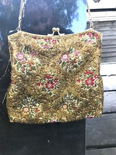 "Vintage fully beaded made in Hong Kong evening bag. The bag has a brocade background with floral design. Gold seed beads are sewn on top of the brocade. There is a brushed gold tone frame with a kiss lock closure. A single box chain for carrying. The interior is a butter color silk material. There is a slip pocket with a made in Hong Kong tag sewn in. The interior is padded. The bag measures approx. 6\" X  6 3/4\".  The bag is in excellent vintage condition. No rips, tears, holes or stains. No Beaded Evening Bags, Bags Vintage, Sewing Tags, Silk Material, A Kiss, Beaded Bags, Box Chain, How To Make Beads, Small Designs