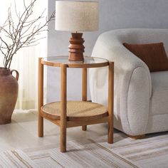 a living room with a chair, table and lamp