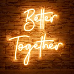 a neon sign that says better together on a brick wall with the words written below it