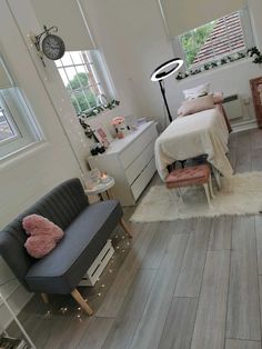 a bedroom with white walls and wooden floors