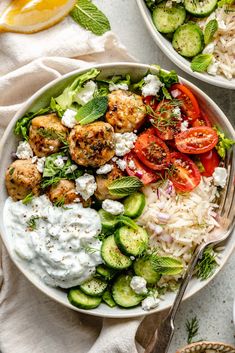 two bowls filled with different types of food and garnished with minty herbs