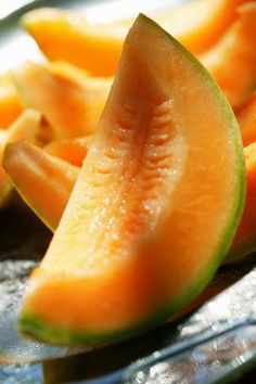 slices of watermelon sitting on top of a glass plate