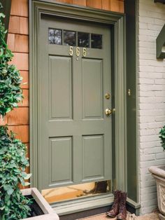 a green front door with the number 666 on it and two brown boots outside