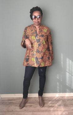 This beautiful African print tunic is made out of 100% wax cotton. It is an easy pull on top with no zippers or buttons. It can be worn for any occasion by styling it differently. Include your measurements in the order notes so we can make sure you are selecting the right fit. DETAILS & CARE - Full Length 30 inches - Sleeve length 24 inches - V-neck - Three-quarter sleeves - Pleat in the back - 100% wax cotton - Hand or machine wash cold recommended to preserve color brilliance Fitted Long Sleeve Tunic With Floral Print, Fitted Long Sleeve Floral Print Tunic, Fitted Long Sleeve Printed Tunic, Long Sleeve Brown Tunic For Fall, Brown Long Sleeve Tunic For Fall, Long Sleeve Cotton Blouse With Batik Print, Ankara Blouse, Ladies Long Top, Top With Long Sleeves