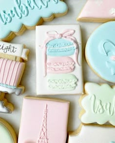 some cookies that are sitting on top of a table with the words welcome to paris and eiffel tower