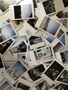 many polaroid pictures are arranged together on the floor