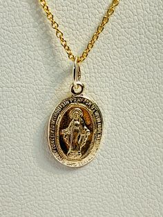 Virgin Mary Pendant, sku 1690 C Material : 14k Gold Handmade, Made in USA Price per pedant. Size: 8X13 mm, 0.25 x 0.50 in This listing is only for the pendant, not with the chain. We have many chains to choose from here... https://www.etsy.com/shop/AlohaPearlsHawaii?ref=simple-shop-header-name&listing_id=809788996&search_query=14k+chain We import Tahitian pearls straight from the crystal-clear lagoons of French Polynesia. Over the last 10 years of working with Tahitian pearl farmers and auction 14k Gold Pendant With Miraculous Medal, 14k Gold Miraculous Medal Pendant, Elegant Miraculous Medal Round Pendant Jewelry, 14k Gold Jewelry With Miraculous Medal, 14k Gold Necklace With Miraculous Medal For Anniversary, 14k Gold Miraculous Medal Jewelry In Gold, 14k Yellow Gold Necklace With Miraculous Medal, 14k Gold Miraculous Medal As Gift, 14k Gold Miraculous Medal As A Gift