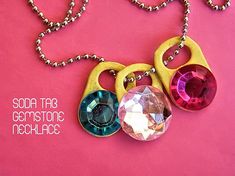 three necklaces with different colored stones hanging from them on a pink background and the words soma tara gemstone necklace written below