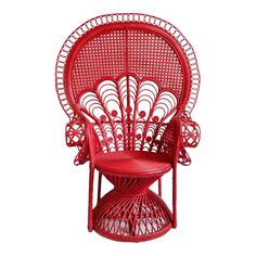 a red wicker chair sitting on top of a table