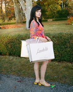 a woman holding a shopping bag in her hands