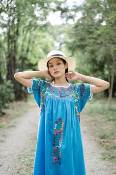 "Beautiful Mexican dress in shade of light blue with floral embroidery. Mexican traditional dress. Bright colorful floral embroidery. With White crochet lace on neck and sleeves. Tailored chest with little people on smocking. Conditions : in good vintage condition **difference color under armpits (shown in the last picture) BEST FIT = M Please be sure to check the measurements to insure a perfect fit. Details and Measurements (Inch) BUST: 46 \"measure from armpit to armpit SHOULDER TO SHOULDER: Light Blue Floral Embroidered Summer Dresses, Light Blue Floral Embroidered Dress For Summer, Light Blue Floral Embroidery Dress For Summer, Light Blue Summer Dresses With Floral Embroidery, Summer Light Blue Dress With Floral Embroidery, Light Blue Embroidered Summer Dress, Traditional Blue Dress With Embroidered Sleeves, Traditional Light Blue Summer Dress, Light Blue Embroidered Beach Dress