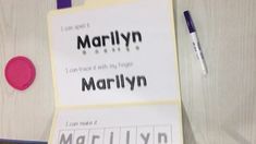 a piece of paper with the word marilyn on it next to a pen and marker