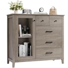 a wooden cabinet with drawers and books on top