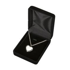 a heart shaped pendant in a black box on a white background with a chain attached to it