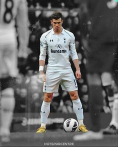 a man standing next to a soccer ball