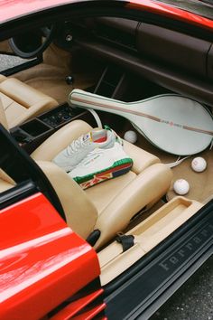 the interior of a sports car with various items in it