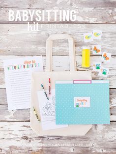 a babysitting kit sitting on top of a wooden table next to a bag