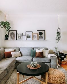 a living room filled with lots of furniture and pictures on the wall above it's coffee table