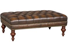 a brown leather bench with wooden legs and nail polishing on the bottom, in front of a white background