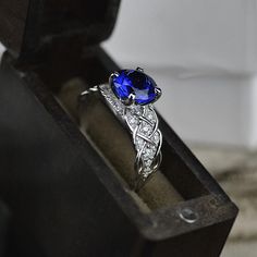 This one of a kind ring features beautiful lattice design which embeds gorgeous jewels of your choice and elegantly twists into the main center stone. The default design option features 2 Carat Round 8mm Created AAAAA -Grade SapphireEngagement Ring with 24 - 0.2 CTW Moissanite (HI I2) Accent Stones 14K White Gold Ring. As well please remember it takes up to 19 days to make and ship this item. Please remember that you can customize this ring in any way you would like in 3D. Celtic Engagement Rings, Blue Sapphire Necklace, Blue Engagement Ring, Diamond Anniversary Bands, 19 Days, Gothic Rings, Sapphire Engagement Ring Blue, White Gold Engagement, White Gold Engagement Rings