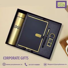 a black and gold corporate gift box with a pen, coffee cup, and notebook