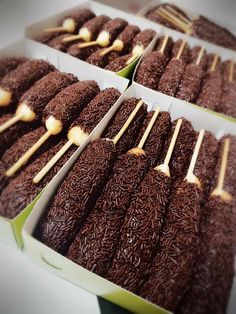 four boxes filled with different types of chocolate cake sticks and marshmallow toppings