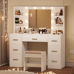 a white vanity with lights on it and a stool in front of the mirror that is open