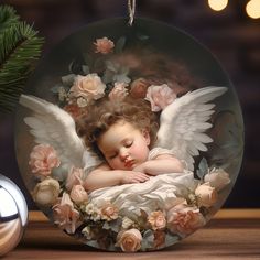 a glass ornament with an angel sleeping on it