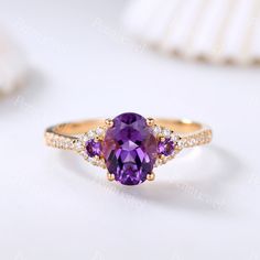 Unique amethyst engagement ring,6x8mm oval shaped amethyst ring,Moissanite band,Vintage amethyst wedding ring,Anniversary gift for her Main Ring Metal Type: 10k/14k/18k solid rose/white/yellow gold Bottom Band Width:1.2mm Center Stone: 6X8mm oval shaped amethyst Side Stone:2mm round cut amethyst+ 0.15ct moissanites This ring can be matched with other wedding band. See the matching band please visit: https://www.etsy.com/shop/PENNIjewel?ref=listing-shop2-all-items-count%C2%A7ion_id&section_id Exquisite Oval Amethyst Ring For Wedding, Exquisite Oval Amethyst Wedding Ring, Exquisite Oval Amethyst Ring For Anniversary, Exquisite Amethyst Ring For Wedding, Oval Brilliant Cut Amethyst Ring For Wedding, Elegant Oval Amethyst Promise Ring, Dainty Oval Amethyst Wedding Ring, Amethyst Wedding Ring, Amethyst Wedding Rings