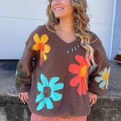 This trendy sweater combines the relaxed comfort of an oversized fit with a touch of floral elegance. The oversized silhouette offers a cozy and laid-back vibe, perfect for everyday wear. Whether you're pairing it with jeans for a casual day out or dressing it up with a skirt for a more polished outfit, our V-Neck Oversized Floral Pullover Sweater is the ultimate choice for a fashionable and versatile outfit. Brown Cotton Sweater For Spring, Oversized Casual Spring Sweater, Casual Oversized Sweater For Spring, Casual Knit Sweater With Floral Print, Fall Cotton Sweater With Floral Print, Cozy Long Sleeve Sweater With Floral Embroidery, Cotton Floral Print Sweater For Fall, Fall Cotton Floral Print Sweater, Cotton Floral Print Fall Sweater