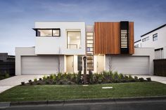 a modern house with wood and white sidings